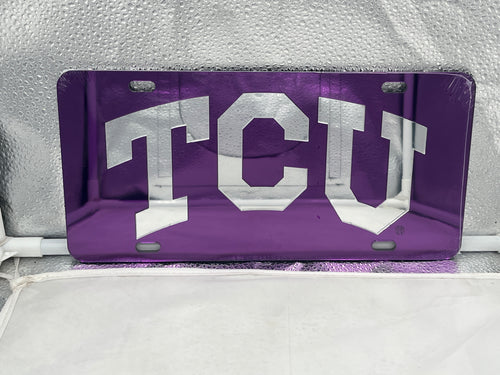 TCU Horned Frogs NCAA Purple Mirrored Laser Cut License Plate Craftique showcasing a vibrant purple design with intricate laser-cut details, perfect for fans to display on vehicles or as home decor.