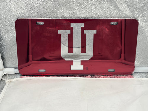 Indiana Hoosiers NCAA Red Mirrored Laser Cut License Plate from Craftique, showcasing vibrant red color and precise laser-cut design of the Hoosiers logo, perfect for vehicle decoration and fan merchandise.