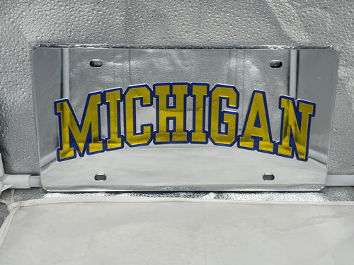 Michigan Wolverines NCAA Silver Mirrored Laser Cut License Plate by WinCraft showcasing a sleek design and iconic logo, perfect for adding team spirit to your vehicle.