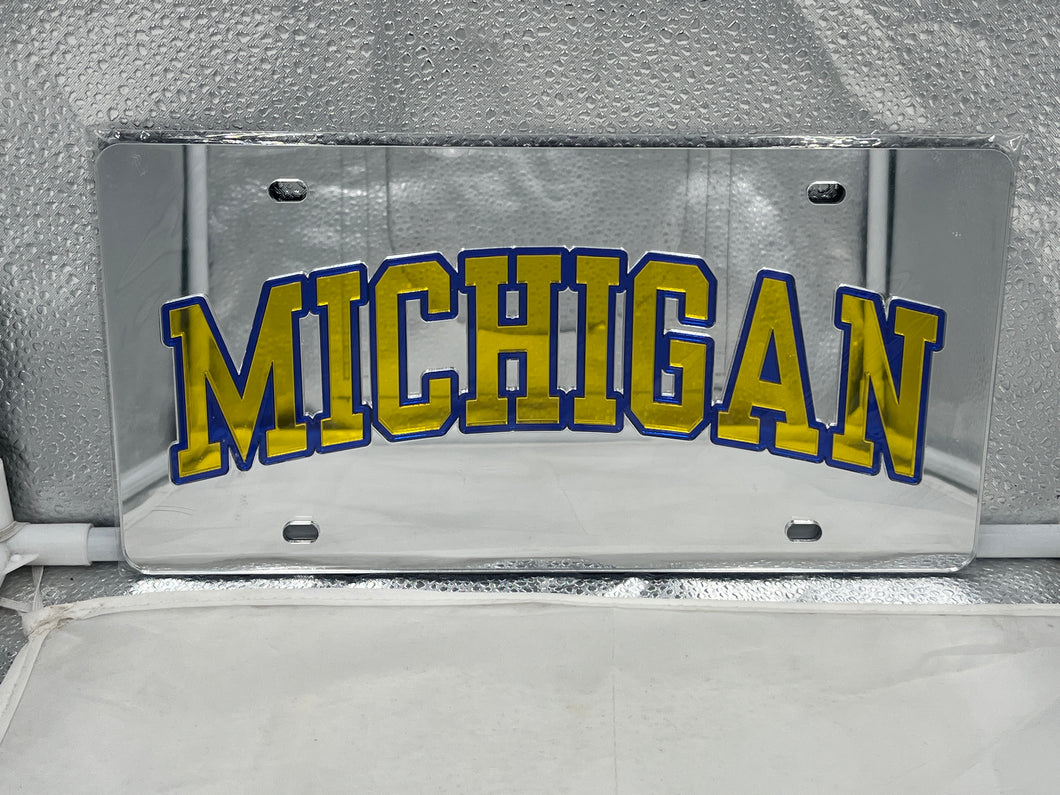 Michigan Wolverines NCAA Silver Mirrored Laser Cut License Plate by WinCraft showcasing a sleek design and iconic logo, perfect for adding team spirit to your vehicle.