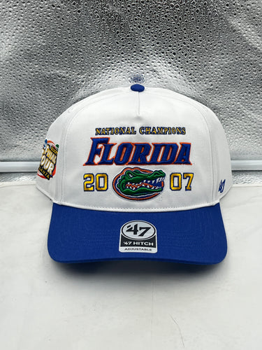 Florida Gators NCAA '47 Brand Champs White Hitch Adjustable Snapback Hat displayed on a wooden table.