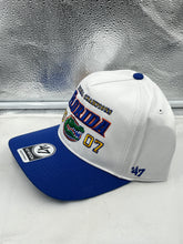 Load image into Gallery viewer, Close-up of the Florida Gators NCAA &#39;47 Brand Champs White Hitch Adjustable Snapback Hat showcasing the team logo.
