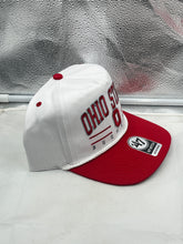 Load image into Gallery viewer, Ohio State Buckeyes NCAA &#39;47 Brand White TT Hitch Rope Adjustable Snapback Hat draped on a table with complimentary Buckeyes merchandise.
