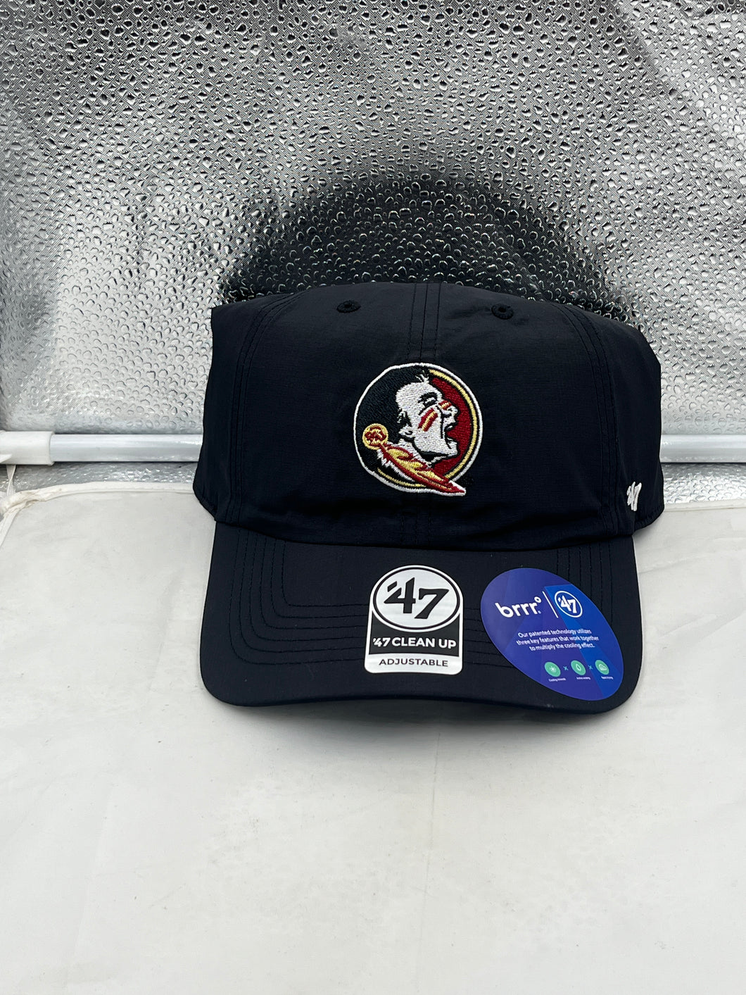 Florida State Seminoles FSU NCAA '47 Brand Black Clean Up Adjustable Hat displayed on a brown wooden table.